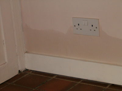 Image of rising damp affecting a plug socket.