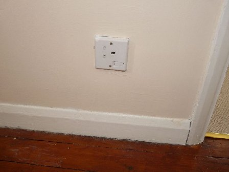Image of a poorly fitted plug socket.
